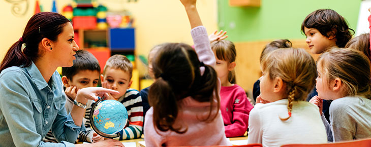 Teacher teaching a lesson to young children